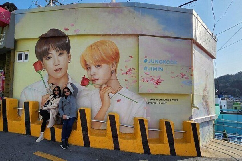 A billboard with a floral design and two individuals holding roses. 2