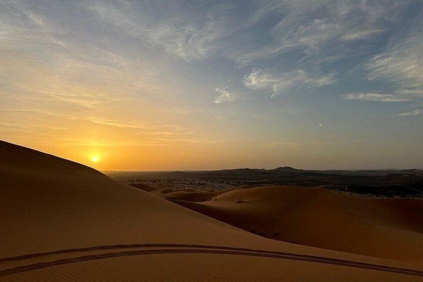 Sand dunes, a sunset, and a distant landscape. 4