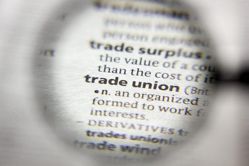 A close-up of a dictionary page with the word 'trade union' highlighted. 5