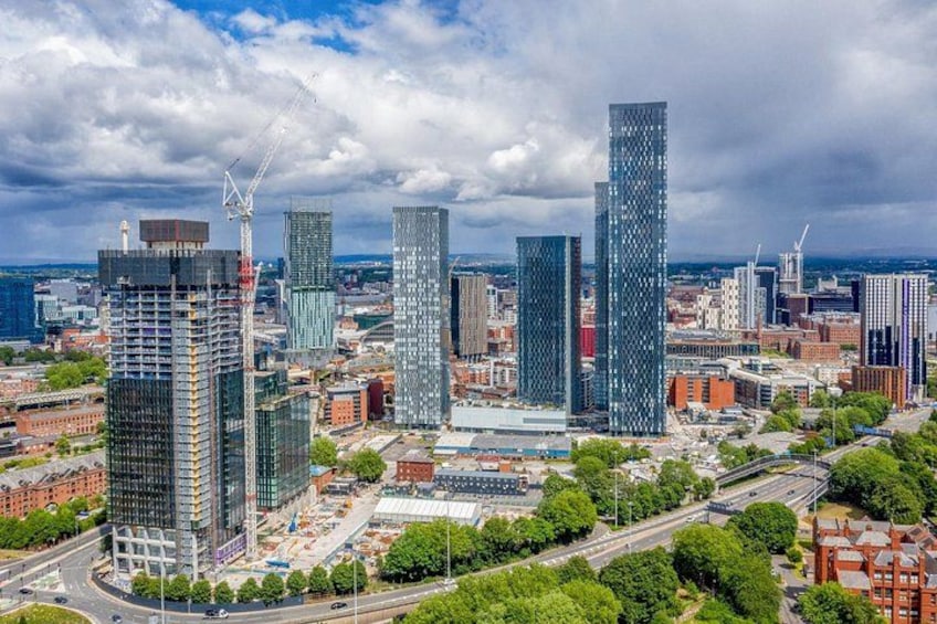 A cityscape with modern skyscrapers, a construction crane, and a mix of greenery. 4