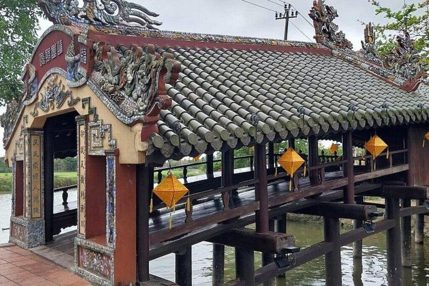 A traditional Chinese pavilion with ornate roof tiles and yellow lanterns. 3