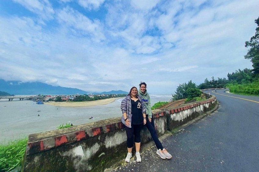 A road with a river and a bridge in the background. 2