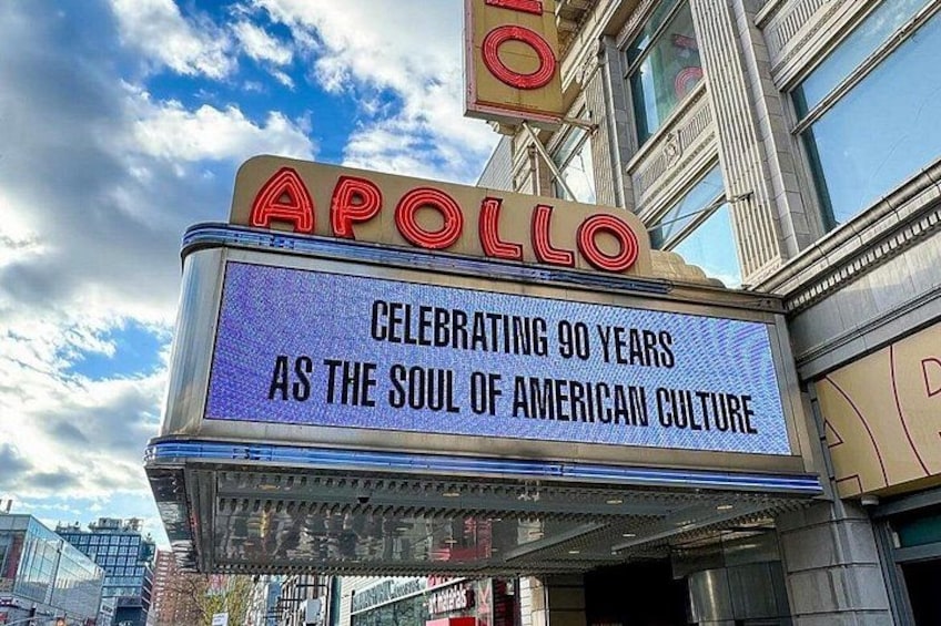 A theater marquee with 'Apollo' and a celebration message. 3