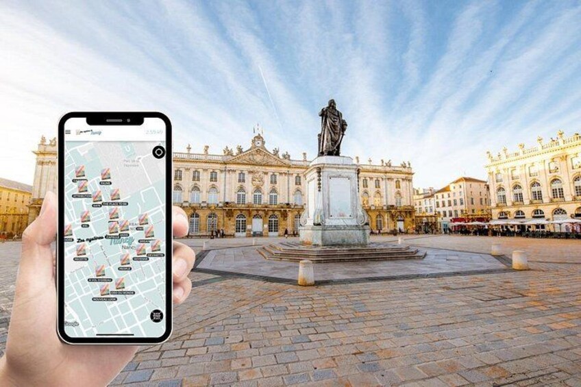 A smartphone displaying a map with a statue and a grand building in the background. 1