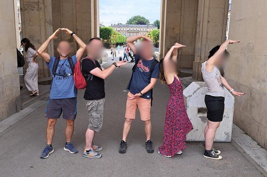 A group of people posing in front of a stone structure. 3