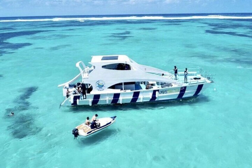 A large yacht anchored in clear turquoise waters. 1