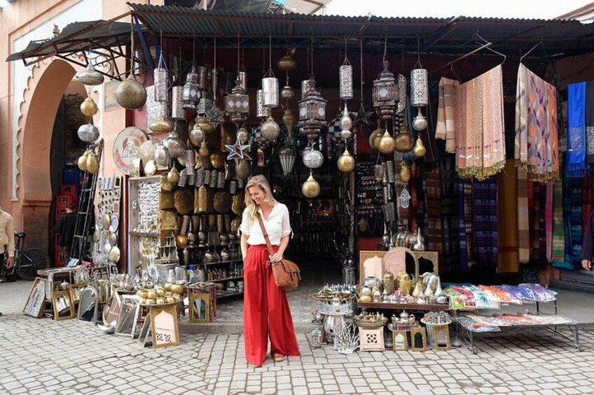 A market stall with various items on display, including hanging lanterns and textiles. 2