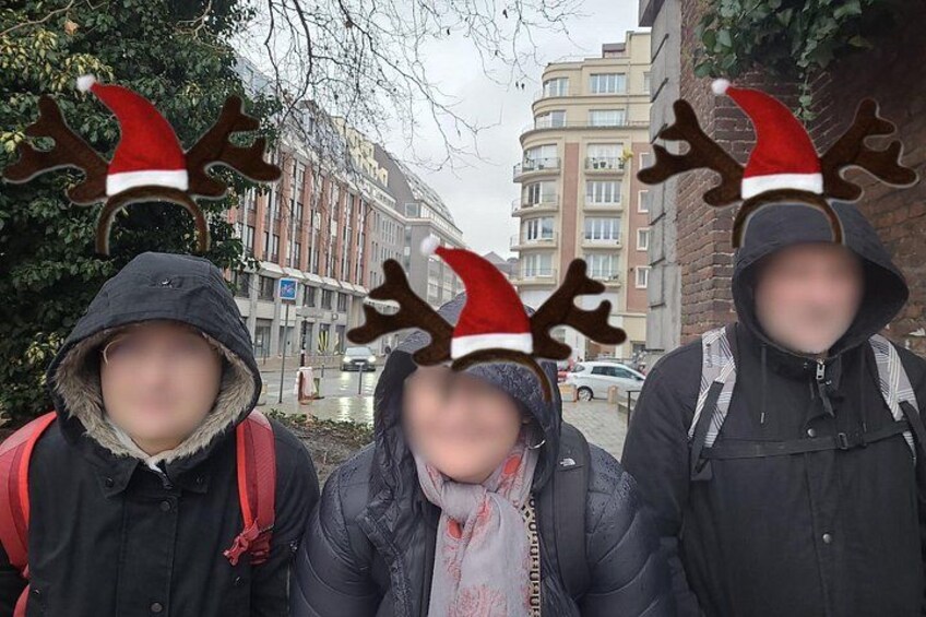 Three people wearing reindeer antlers and hoodies. 5