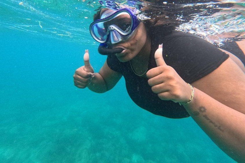 A person underwater giving a thumbs-up. 1