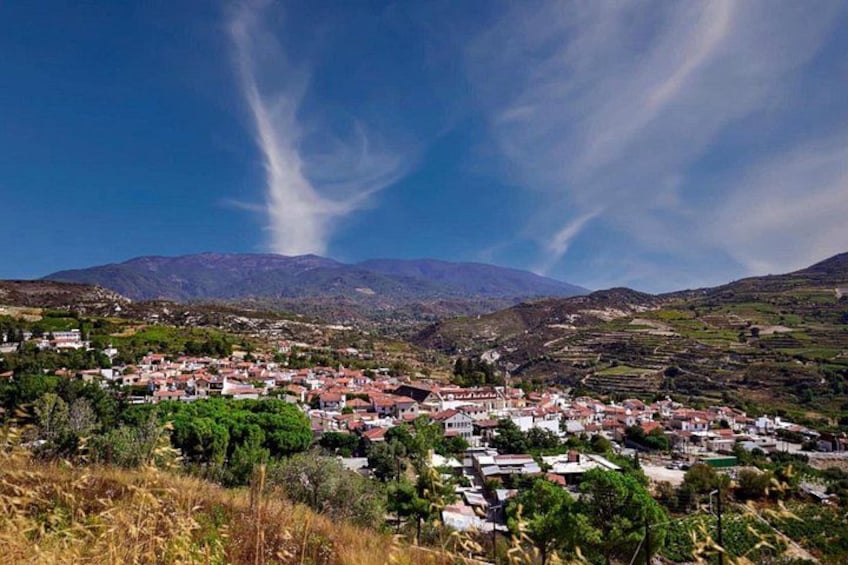 A mountainous landscape with a village, terraced fields, and a clear sky. 5