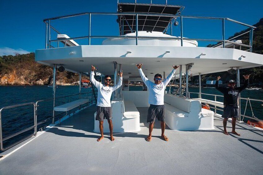 A boat with two people standing on the deck, one with arms raised. 4