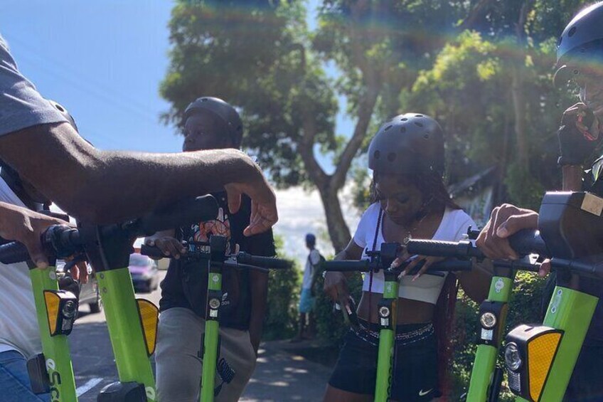 People on bicycles with helmets, a tree, and a clear sky. 3