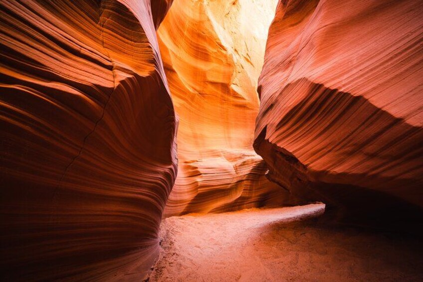 A narrow canyon with smooth, curved rock walls and a narrow passageway. 2