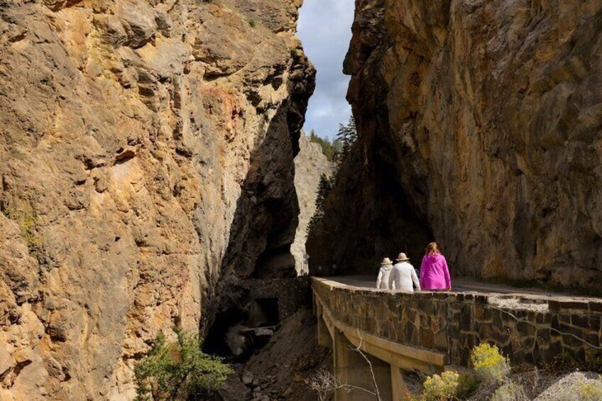 A rocky canyon with a narrow bridge. 2