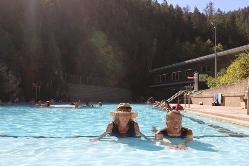 A swimming pool surrounded by trees and a building. 1