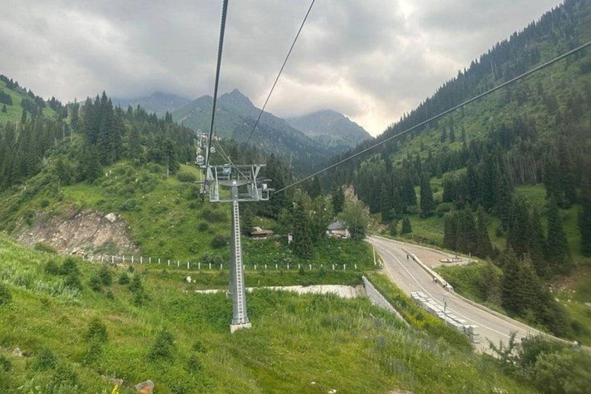 A cable car system, a road, and a mountainous landscape. 3
