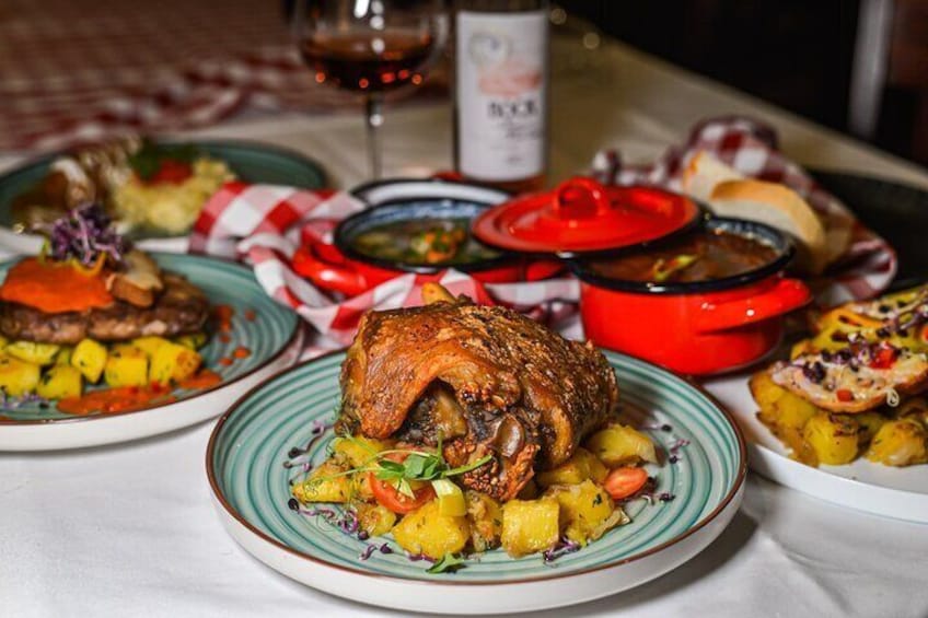 A table with various dishes including roasted meat, potatoes, and vegetables. 5