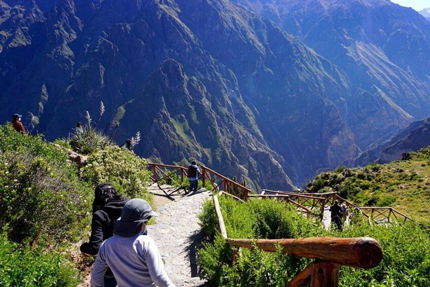 A mountainous landscape with a wooden staircase leading down. 2
