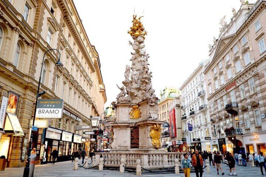 A public square with a central fountain, surrounded by historic buildings and shops. 5