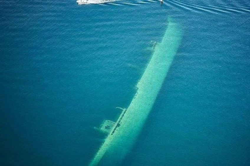 A submerged shipwreck in clear blue water. 2
