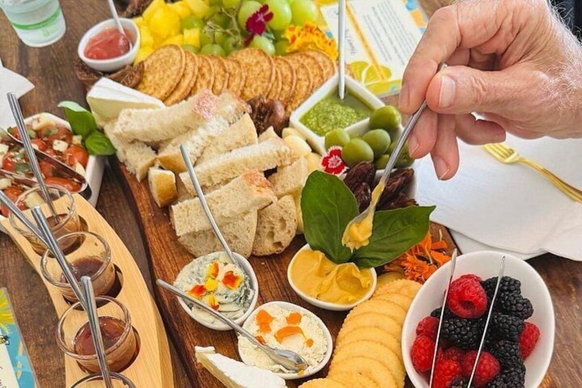A charcuterie board with various cheeses, fruits, and bread. 5