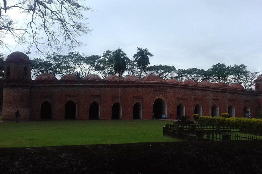 A brick building with arched windows and a dome. 4