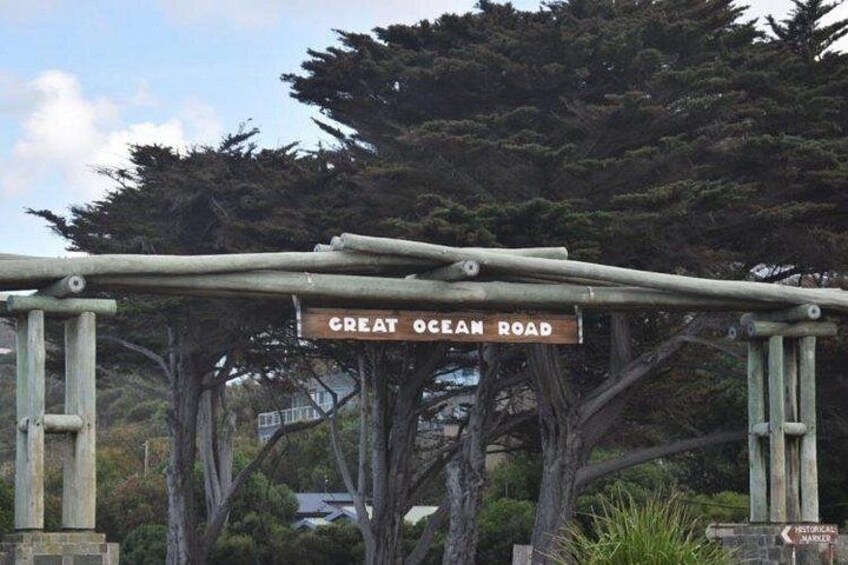A wooden sign with 'Great Ocean Road' written on it, supported by a metal structure. 2