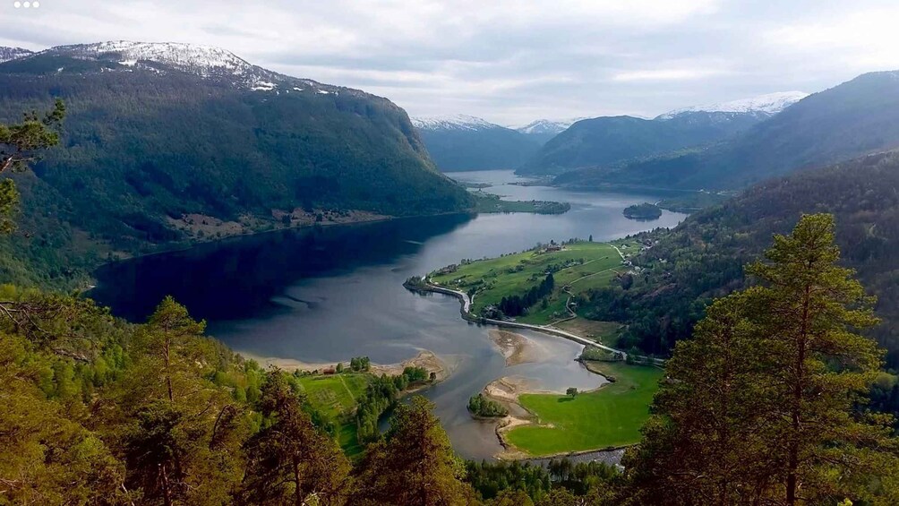 A lake surrounded by mountains and dense forests. 3