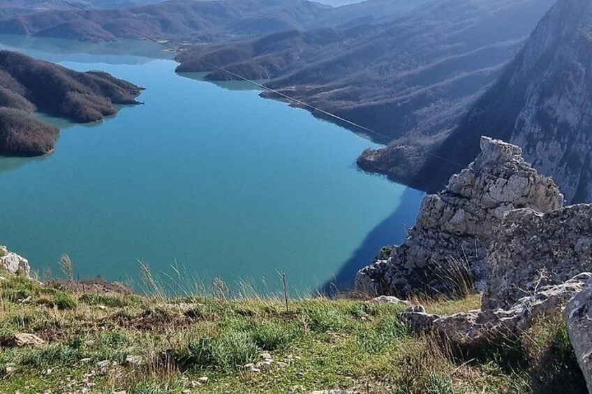 A mountain landscape with a lake and rocky terrain. 3