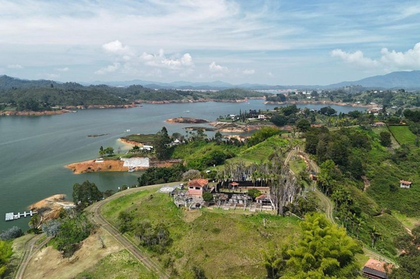 A river, a small settlement, and surrounding greenery. 2