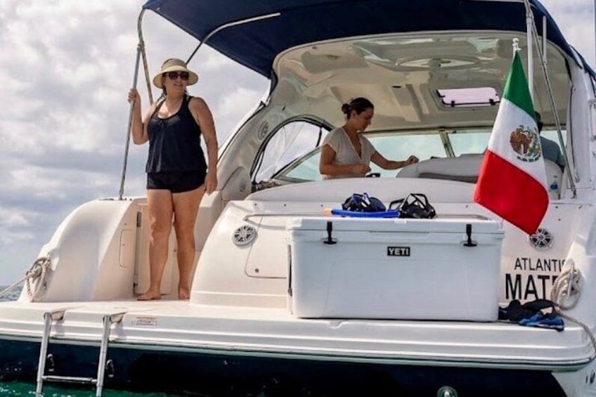 A boat with a flag, a ladder, and a person standing on the deck. 5