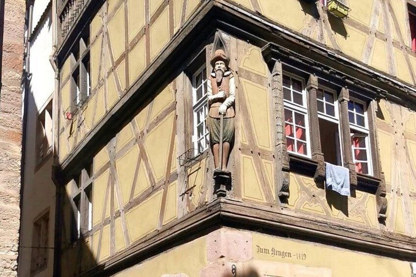 A half-timbered building with a visible chimney and a hanging laundry. 2