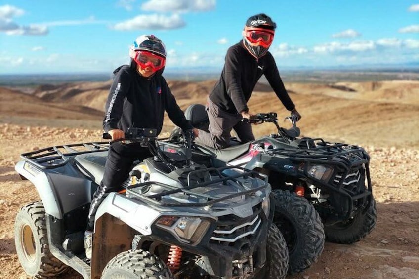Two people on ATVs in a desert landscape. 4