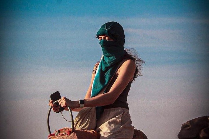A person riding a bicycle with a backpack and a phone. 2