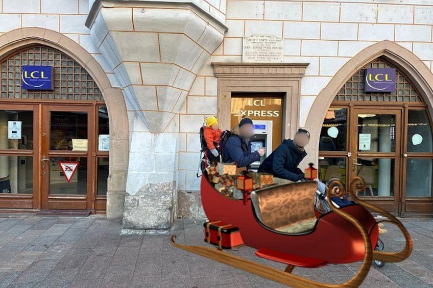 A red sleigh with two people, a building with 'LCL' signage, and a triangular warning sign. 2