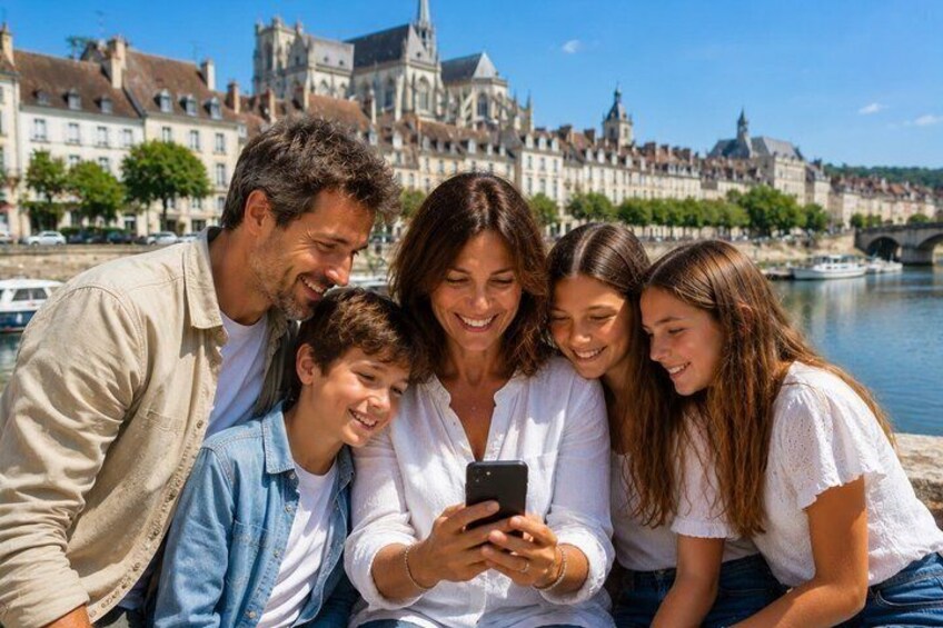 A family of five by a river with historic buildings in the background. 2