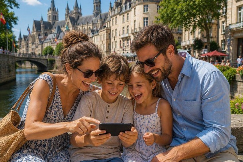 A family of four sitting by a canal with historic buildings in the background. 2