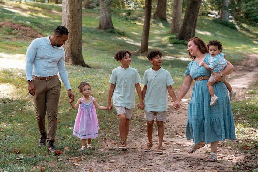 A family walking on a dirt path in a wooded area. 3