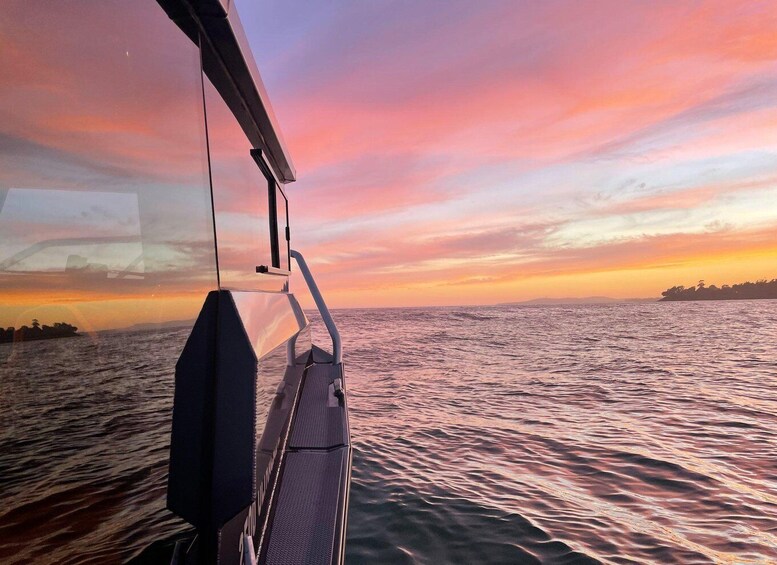 A boat's deck with a sunset over the ocean. 5