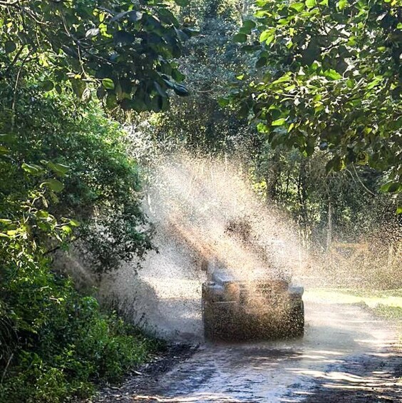 A water jet spraying from a concrete structure in a wooded area. 1
