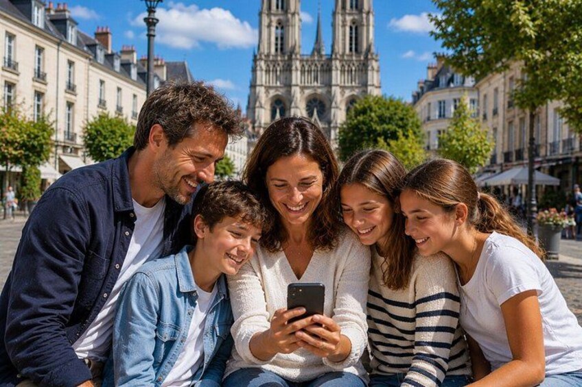 A group of people sitting on a bench in a public square with a historic building in the background. 2