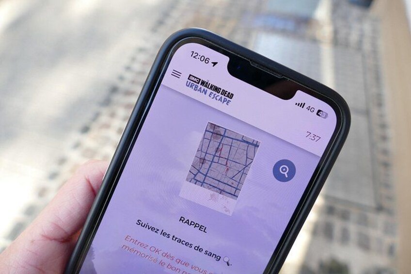 A smartphone displaying a map with a grid overlay, possibly for navigation or tracking. 1