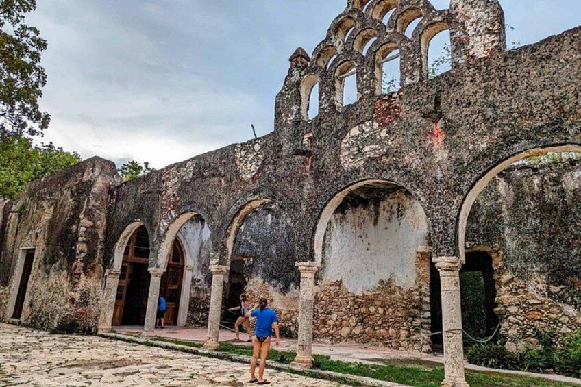 A historical building with arched doorways and a stone facade. 5