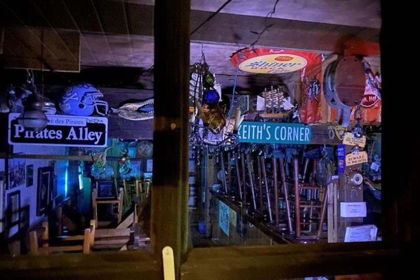 A shop window with signs reading 'Pirates Alley' and 'EITH'S CORNER,' displaying various items like model ships, toys, and decorations. 5