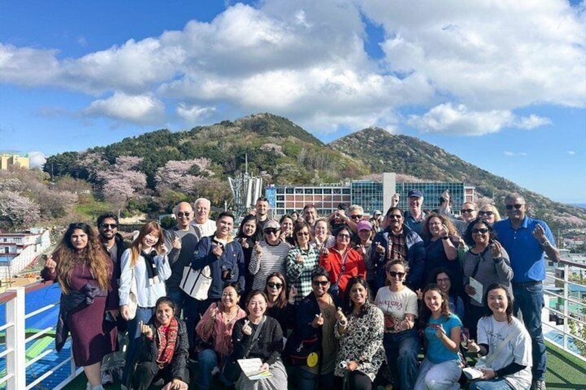 A group of people on a boat with a mountainous landscape in the background. 5