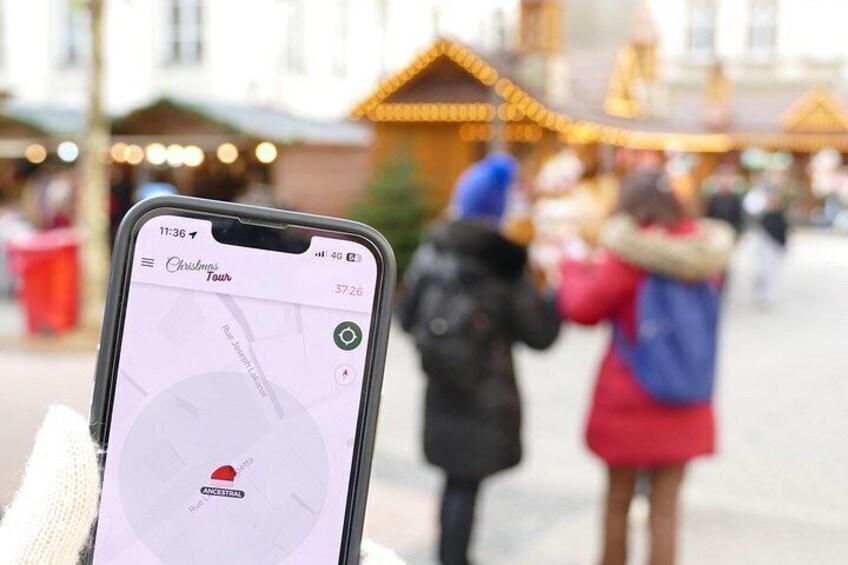 A smartphone displaying a map with a location pin, a person holding a map, and a festive market scene in the background. 4