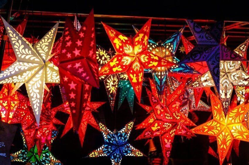 A collection of illuminated star-shaped lanterns in various colors. 1