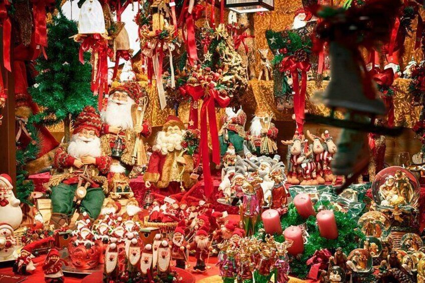 A Christmas display with various decorations including Santa Claus figures, Christmas trees, and ornaments. 3