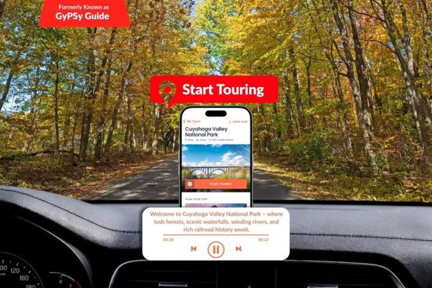 A smartphone mounted on a dashboard displaying a scenic view of Cuyahoga Valley National Park. 1