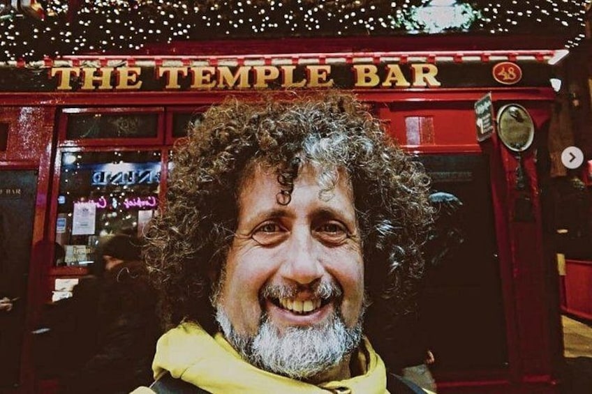 A person in front of a red bar with the sign 'THE TEMPLE BAR'. 2